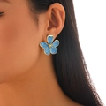 Elegant gold-edged blue enamel flower stud earring worn by a model in a close-up shot - Matte Five-Petal Flower / Blue