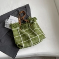 Grass green woven tote bag with white grid pattern and brown leather handles - Green