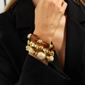 Close-up of layered resin bead bracelets featuring amber and gold geometric accents - Mixed Amber (6899)