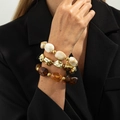 Detail of layered beaded bracelets with marble resin, gold beads, and amber tones - Mixed Marble (6900)