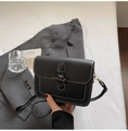 Classic black crossbody bag with white contrast stitching and elegant horn buckle closure - Black