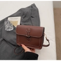 Dark brown leather shoulder bag with horn buckle closure and contrast white stitching - Coffee