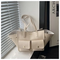 Detail of creamy white lychee leather tote with front pockets and golden hardware - White