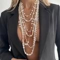Detailed close-up of multilayered baroque pearl necklace set with golden chains - Gold + White (7498)