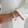 Nahaufnahme eines transparenten, gewellten Armreifs aus Acryl am Handgelenk - Transparenter Wellenstromlinien-Stil (0156) / Transparent