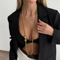 Long golden beaded pearl necklace styled on model with black suit for a luxury look - Gold Round Bead Long Style (07502)
