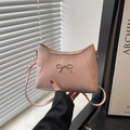 Chic pink faux leather shoulder bag with golden metallic bow and adjustable strap - Pink