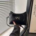 Chic black faux leather shoulder bag with a gold metal bow and adjustable strap - Black