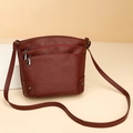 Close-up of wine red vintage shoulder bag with double zipper pockets and rivet details - Burgundy