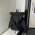 Minimalist black matte backpack with bunny ears and drawstring closure in natural lighting - Black