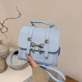 Light blue faux leather mini bag with silver metal bow and top handle - Blue