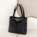Close-up of black tote bag with white star pattern and functional side pockets - Black