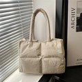 Beige quilted puff tote bag with soft padded handles and textured finish for women - Khaki
