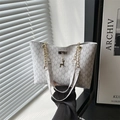 White monogram tote bag with gold chain strap and a deer pendant charm in minimalist style - Rick Morty McDonald White