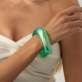 Dettaglio di bracciale in resina verde iridescente con riflessi aurora al polso - AB Verde (03031)
