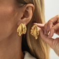 Close-up of golden irregular textured earrings with vintage ripple design on a model - Gold Style (3833)
