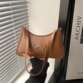Brown faux leather shoulder bag with silver bow accent and minimalist crescent shape - Brown