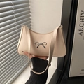 Elegant beige PU leather underarm bag with a silver metal bow detail and thin strap - White
