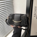 Minimalist black faux leather crossbody bag with abstract letter print and gold accents - Black