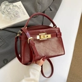 Chic burgundy leather underarm bag with gold metallic lock and adjustable strap - Red