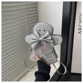 Close-up of a silver sequin gingerbread man crossbody bag with a large bow and pink hearts - Silver