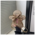 Detail view of gingerbread man crossbody bag with gold glitter material and bow - Gold