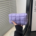 Handheld lavender quilted puffer makeup bag with soft textured grid design and zipper - Purple