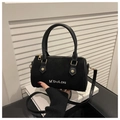 Detail of black matte Boston bag with leather handles and white embroidered branding - Black