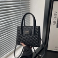 Minimalist black quilted handbag with golden bow detail and top handles for women - Black