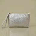 Detailed view of silver woven leather clutch with metallic finish and gold zipper closure - Silver