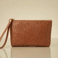 Detail of brown woven leather texture on wristlet pouch with golden zipper hardware - Brown