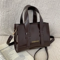 Dark brown patent leather handbag with glossy finish and detachable shoulder strap - Brown