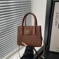 Brown quilted tote bag with golden bow detail and adjustable shoulder strap - Brown