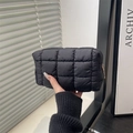 Portable black quilted nylon cosmetic bag with elegant gold zipper and soft padding - Black