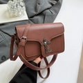 Brown litchi grain crossbody bag featuring vintage silver cross and chain accent - Brown