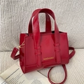 Glossy red faux leather handbag with gold lettering and adjustable crossbody strap - Red