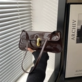 Deep brown patent leather baguette bag with minimalist golden buckle and slim shoulder strap - Brown