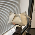 Elegant cream cloud pleated crossbody bag with fine leather texture and silver chain strap - White