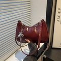Glossy dark red patent leather handbag with silver bow pendant for modern fashion - Red