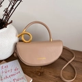 Minimalist beige leather saddle bag featuring a stylish gold metal knot buckle detail - Khaki