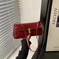 Fashionable dark red glossy patent leather shoulder bag with gold clasp detail - Red