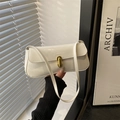 Glossy white patent leather baguette bag with a golden oval twist lock clasp - White