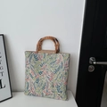 Floral tapestry tote bag with bamboo handles in a minimalist home interior setting - Green Flower