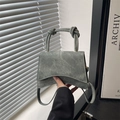 Mini trapezoid crossbody bag in sage green denim fabric with unique knotted handle strap - Green