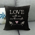 Detail of black linen pillowcase with white LOVE lettering and pink heart on a sofa - Love will see us through Style (13) / 45*45cm (No Core)
