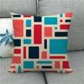 Linen square throw pillow cover featuring modern geometric pattern on a grey sofa - Red and Blue Abstract Geometric (1)