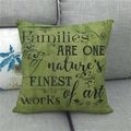 Detailed texture of linen pillowcase with black family quote on a grey sofa - Families Are Art Green