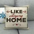 Linen decorative pillow cover with LIKE staying HOME text on a grey fabric sofa - Like Staying Home Simple