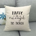 Close-up of linen pillow cover with Brave enough TO TEACH quote on grey sofa - Brave enough to Teach (12)