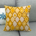 Close-up of geometric diamond pattern on linen cushion cover on a grey sofa - Yellow Brown Diamond (6)